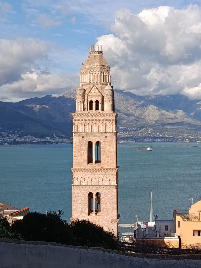 Captivating view of the bell tower in Gaeta, Italy with a stunning seascape backdrop.